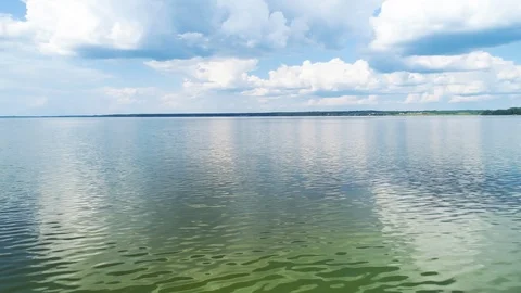 Flying over the mirror, blue smooth surface of the lake. 스톡 동영상 104375543
