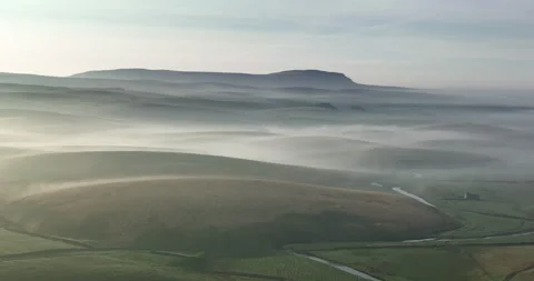 Flying over a mist covered valley Stock Footage 248021627