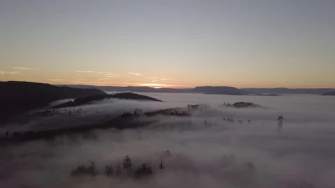 Flying over the mist on sunset with mountains and trees1080 ungraded Stock Footage 105953370