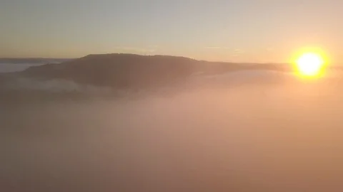 Flying over the mist on sunset over trees 1080 ungraded Stock Footage 105953364