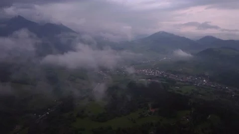 Flying over misty mountains and hills in the countryside. A beautiful gloomy day Stock Footage 196980331