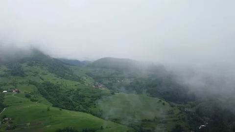 Flying over misty mountains and hills in the countryside. A beautiful rainy day Stock-Footage 200814912