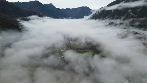 Flying over misty valley Stock Footage 156302734