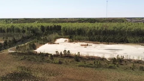 Flying over mixed use land towards Trash Mountain Stock Footage 106524385