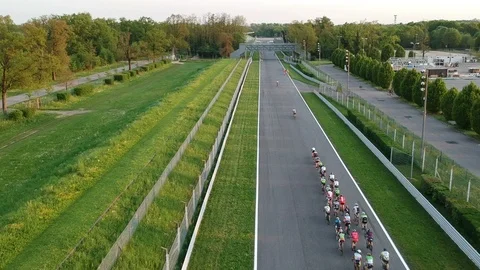 Flying over Monza circuit while running a group of cyclists Video stock 88934405