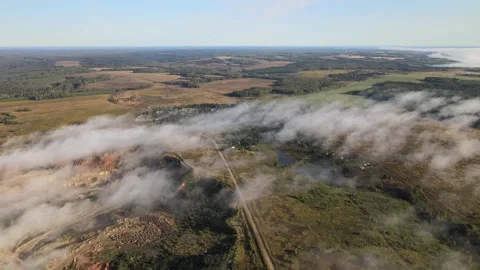 Flying over the morning mists creeping across the countryside Stock Footage 254066341