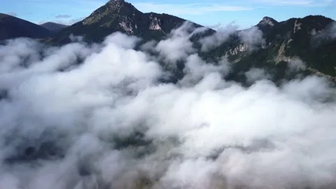 Flying over mountain alpine landscape, misty low clouds.Big mountain. Stock Footage 221788944