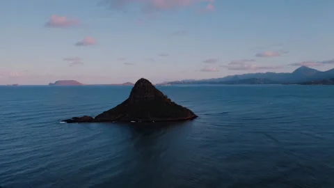 Flying over a mountain in an endless ocean Stock Footage 297303082