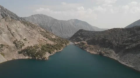 Flying over mountain lake in the Crazy Mountains Stock Footage 166754929