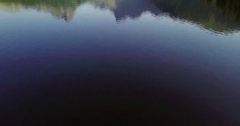 Flying over a mountain lake in the forest 스톡 동영상 126590886
