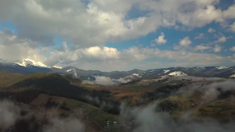 Flying over a mountain landscape in the clouds Stock Footage 155096460
