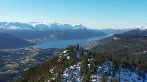 Flying over mountain peak against village in Norway Stock Footage 157884028