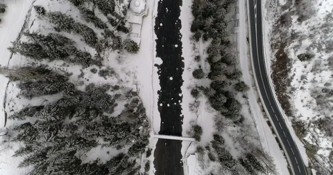 Flying over a  mountain river in a landscape covered with snow. Stock Footage 92515042