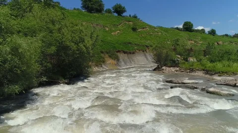 Flying over a mountain river, a strong stream of water. From the air Video stock 86266830