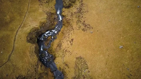 Flying over a mountain river through green fields Video stock 85626048