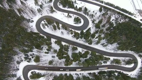 Flying over mountain road pass with traffic , in winter Video stock 71847311