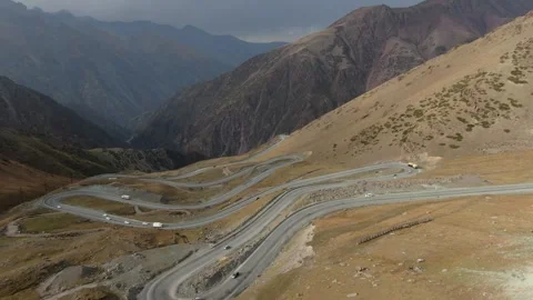 Flying over the mountain road which passing through a mountain pass in Stock Footage 321858584