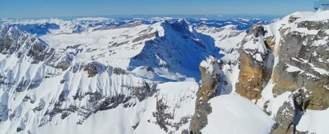 Flying over mountain tops closely, in the Swiss Alps. Sun is shining. Aerial Stock Footage 121480839