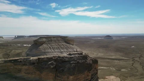 Flying over a mountain with a view of a beautiful blue sky with clouds Stock Footage 237945657