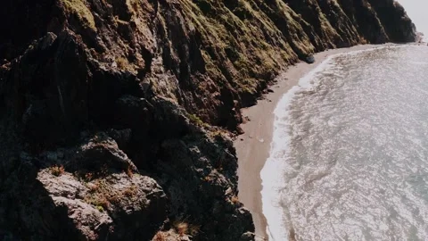 Flying over the mountain with a view of the sea and the rocks near the coast Stock Footage 315784457