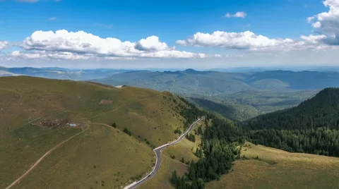 Flying over the mountains and road Video stock 66418571