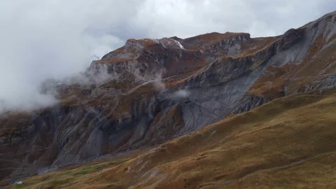 Flying over the mountains covered in clouds of fog Stock Footage 228838791