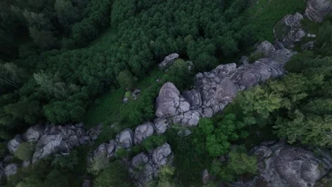 Flying over mountains overgrown with forest and rocks at sunset 3 Stock Footage 255217813