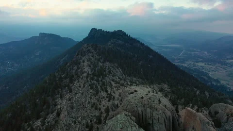 Flying over a mountain's peak with the valley below in Colorado Stock Footage 247363864