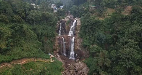 Flying over the mountains with a river and a waterfall in Sri Lanka Stock Footage 100600866
