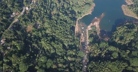 Flying over the mountains with a river and lake in Sri Lanka Stock Footage 100600875