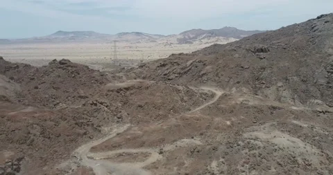 Flying over mountains in them you can see electric towers and roads. Stock Footage 170533486