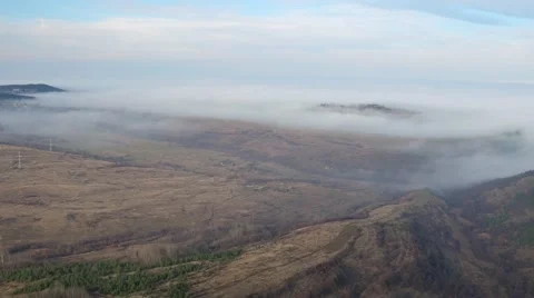 Flying over the mountains turning into cloudy infinity top view Aerial shot Stock Footage 58254017