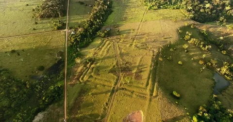 Flying over multiplus square geoglyph in the Amazon rainforest Stock Footage 77210361