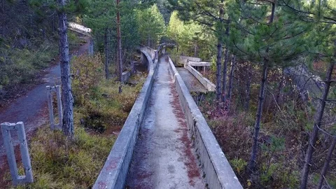 Flying over neglected Olympic bobsleigh track Sarajevo, used by graffiti artists Vídeo Stock 85443191
