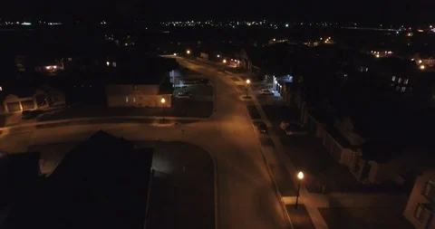 Flying Over Neighborhood Houses On Street At Night Aerial Drone Stock Footage