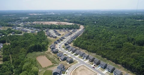 Flying over new housing development in woodland drone aerial 4k Stock Footage 114138315
