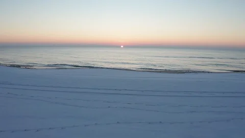 Flying over the ocean and beach at sunrise Stock-Footage 105550331