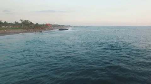 Flying over Ocean Beach With Surfers At Sunset Stock Footage 81214839