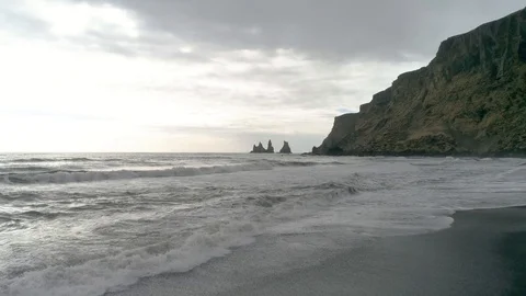 Flying Over Ocean at Black Sand Beach in Iceland in 4k Stock Footage 90228556