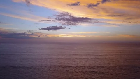Flying over ocean out to two sailboats at sunset Playa Grande Stock Footage 90972577