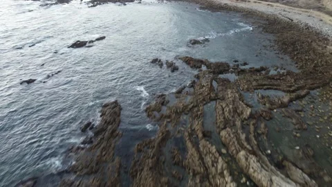 Flying over Ocean Rocks at Sunset Video stock 159720312