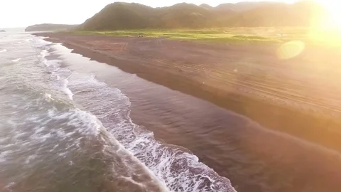 Flying over the ocean. Sea waves. Sunset Pacific Ocean. People in the wild Stock Footage 72656608