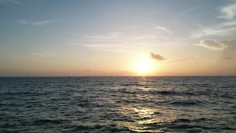 Flying over the ocean sunrise/sunset Stock Footage 247391695