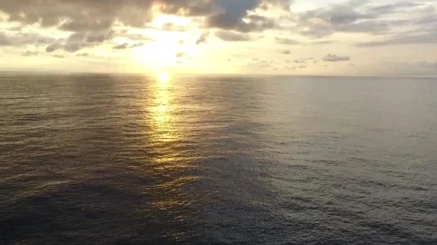 Flying over the ocean at sunset Stock Footage 169778037