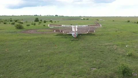 Flying over an old broken abandoned airplane. 4K aerial drone video Stock Footage 132188632