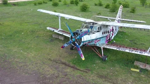Flying over an old broken abandoned airplane. 4K aerial drone video Stock Footage 199421074