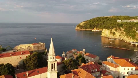 Flying over old buildings with red roofs and church tower. Drone Shot of old Stock Footage 167688697