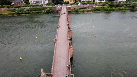 Flying over the Old Charles Bridge in Heidelberg with people walking over it Stock Footage 245972297