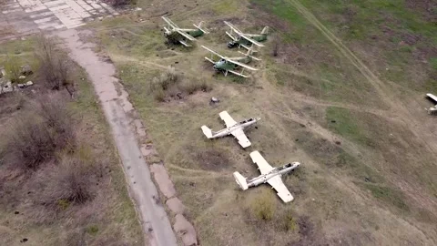 Flying over old destroyed planes. Old Soviet military aircraft in an abandoned Stockbeeldmateriaal 131630113