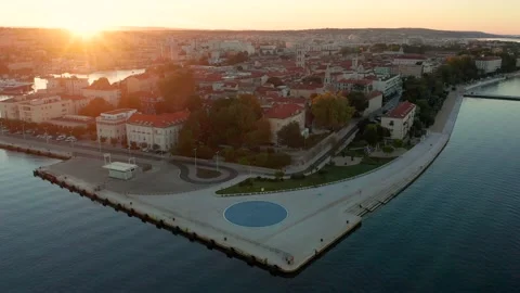 Flying over the old town of Zadar with The Greeting to the Sun monument Stock Footage 220173321